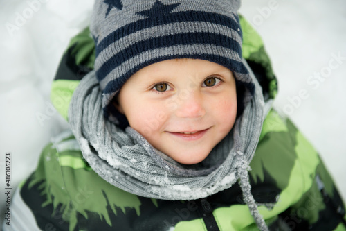 Baby boy in snow outside