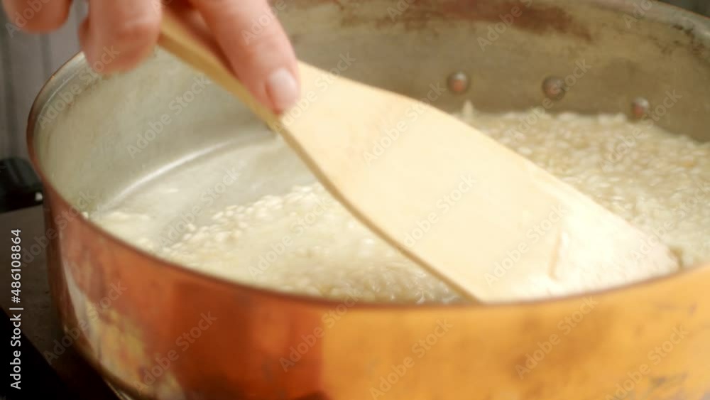Unrecognizable cook preparing risotto in pan Unrecognizable cook preparing risotto in pan