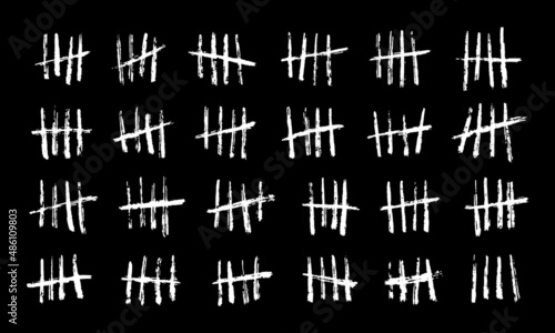 Wall tally marks, prison day counting jail hash symbols. Vector hand drawn chalk lines with slash strokes clustered in groups of four on black chalkboard background, unary numeral system photo