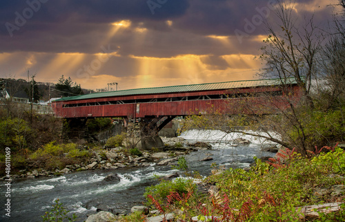 The Taftsville Bridge is a timber-framed covered bridge which spans the Ottauquechee River in the Taftville village of Woodstock, Vermont in the United States. photo