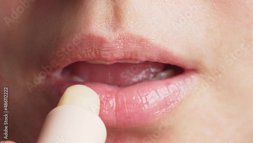 Anonymous female applying balm in morning photo