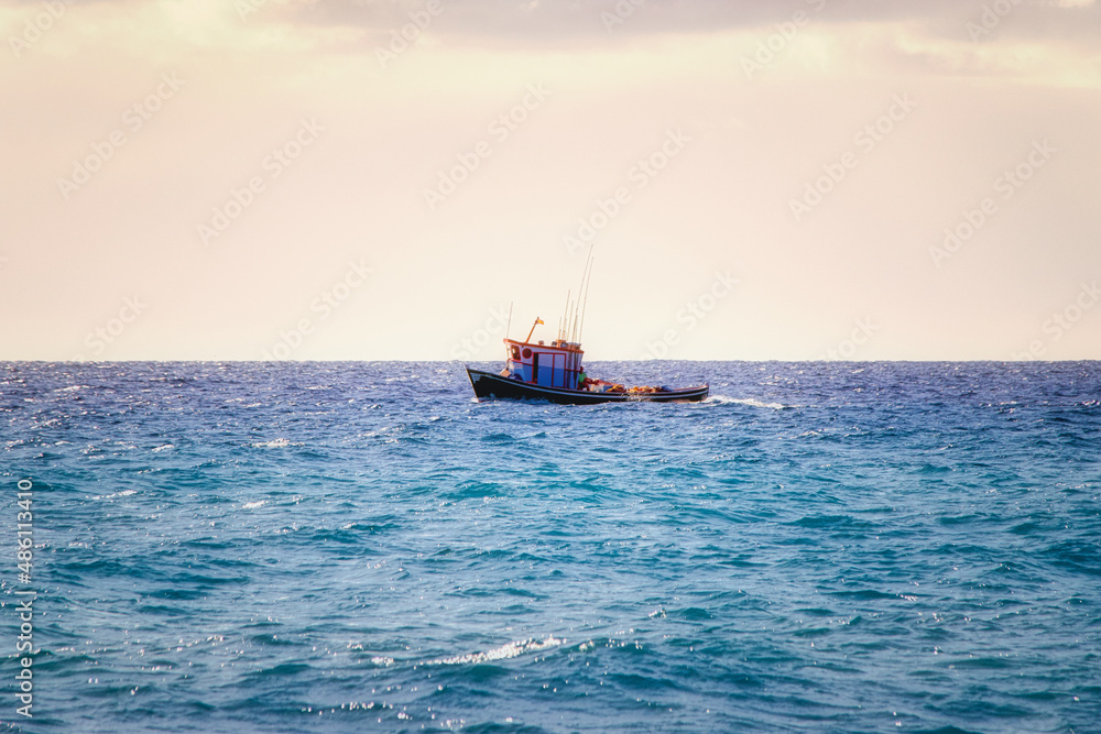 a small fishing boat in the open water on the atlantic ocean