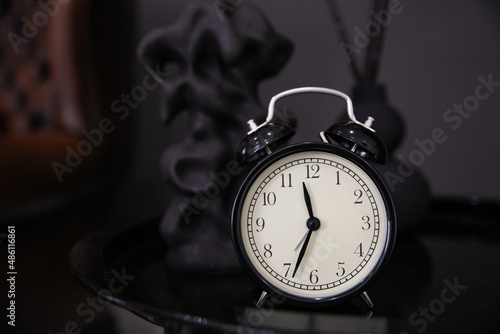 black alarm clock on a black background