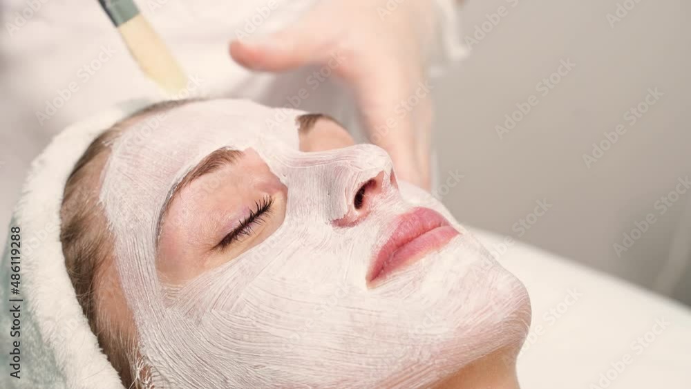 Portrait of moisturizing clay mask for medical design. Woman skin procedure. Natural cosmetic products. Beauty face. Facial cosmetology treatment. Healthcare peeling cream video Portrait of moisturizing clay mask for medical design. Woman skin procedure. Natural cosmetic products. Beauty face. Facial cosmetology treatment. Healthcare peeling cream video