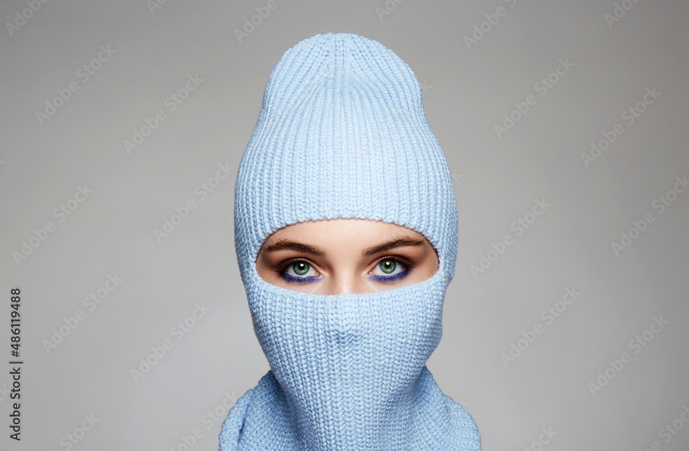 beautiful eyes of girl in blue balaclava. Trendy Mask on pretty woman beautiful eyes of girl in blue balaclava. Trendy Mask on pretty woman