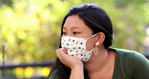 Pensive Asian woman wearing covid-19 face mask outside, Thoughtful Japanese lady