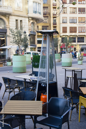 Image of a gas stove for the terrace of a bar that has tables on the street in winter photo