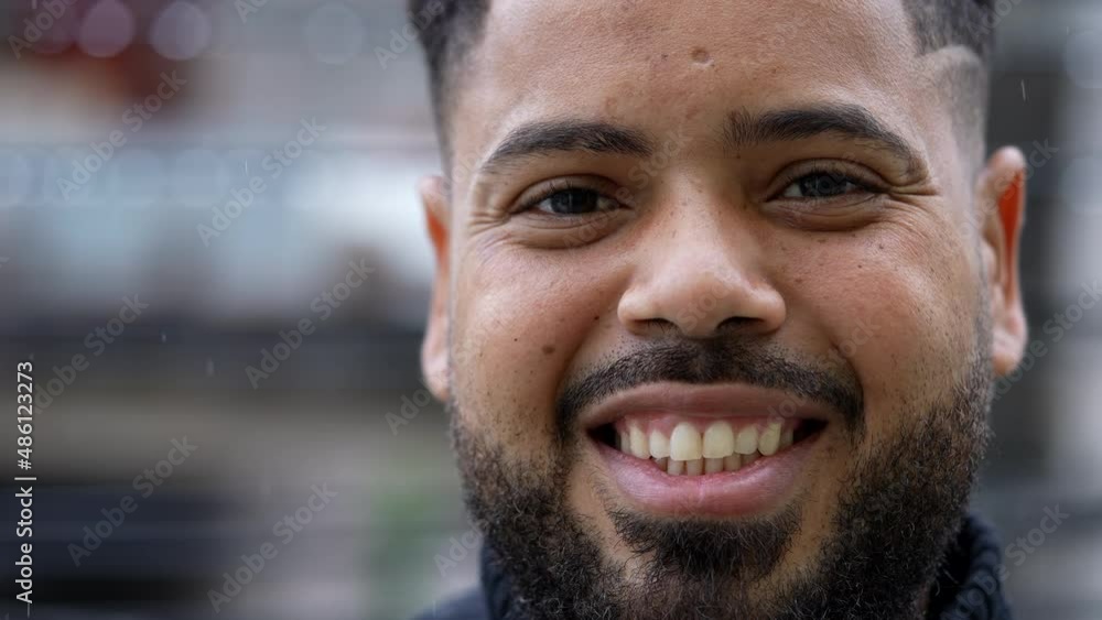 A smiling happy diverse young man portrait face close-up A smiling happy diverse young man portrait face close-up