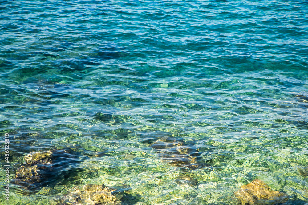 blue sea water background. clear sea water visible seabed.