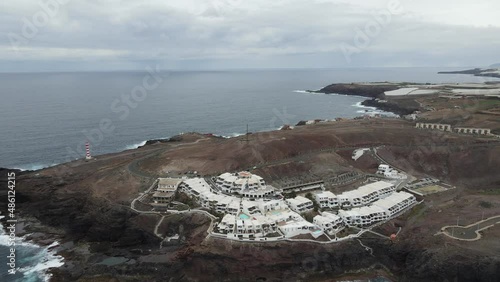 Faro de Sardina de Galdar (Gran Canaria) con rayas blancas y rojas sobre un acantilado. panorámica 360 grados. Vídeo 4k realizado con un dron. photo