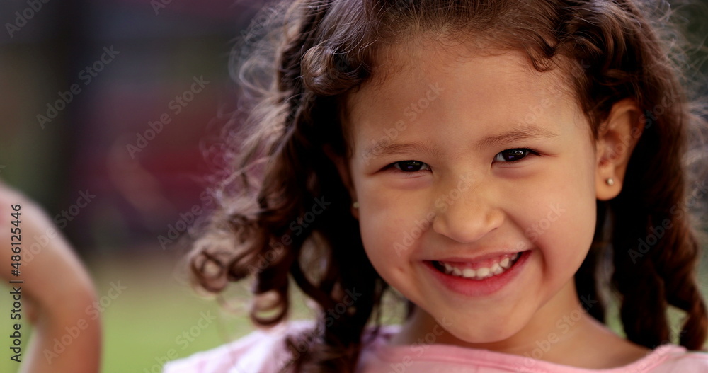 Happy little girl child smiling to camera with joy Happy little girl child smiling to camera with joy
