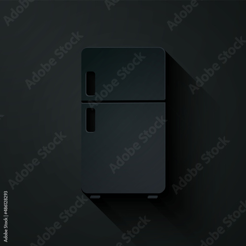 Paper cut Refrigerator icon isolated on black background. Fridge freezer refrigerator. Household tech and appliances. Paper art style. Vector