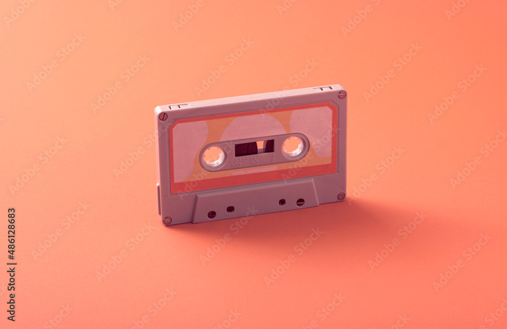 Old Vintage Audio Cassette, Compact Cassette, or Musicassette on a Seamless Trending Colorful Background. Conceptual Photo about eighties music