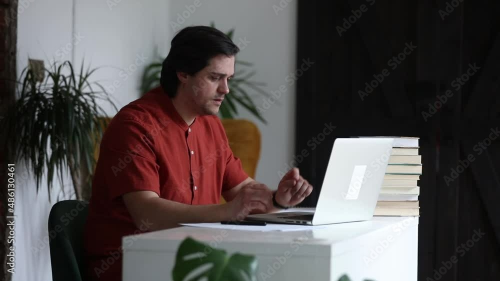 Man working at home office at laptop Man working at home office at laptop