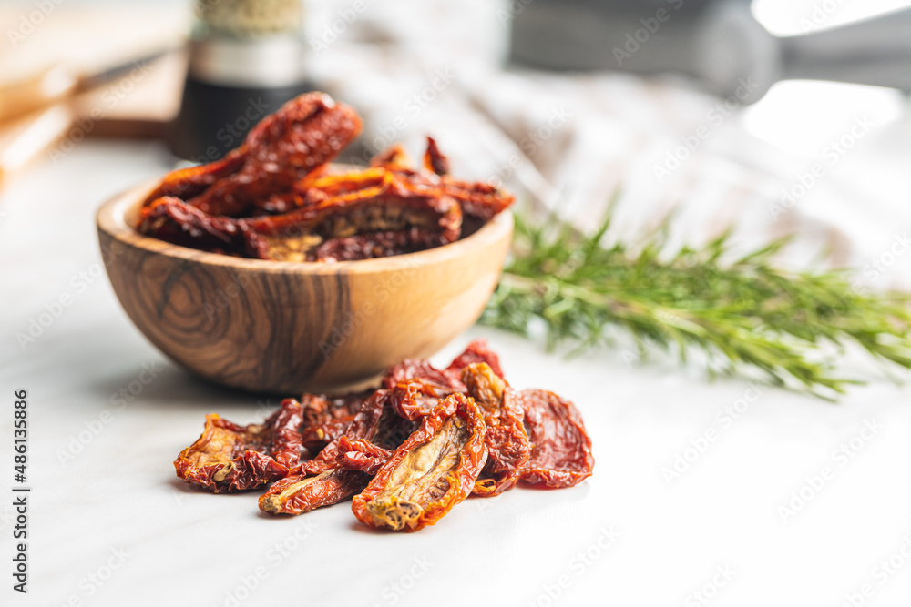 Sun dried tomatoes on white table. Sun dried tomatoes on white table.