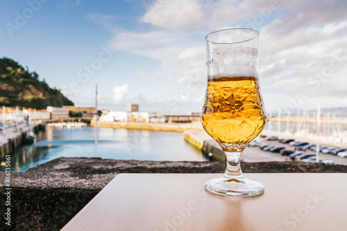 Close-up of a glass of beer on a table with the port in the background