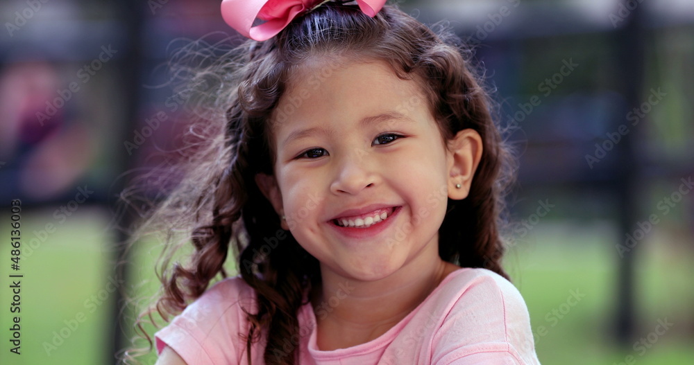 Charming diverse little girl child close-up face portrait smiling outside Charming diverse little girl child close-up face portrait smiling outside