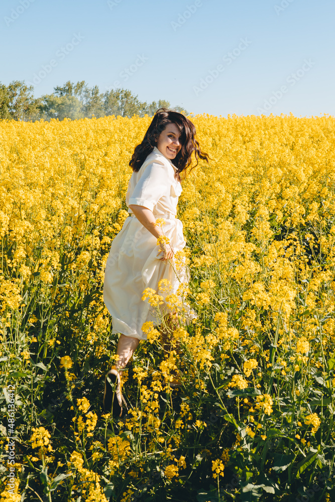 woman standing in rapeseed field
