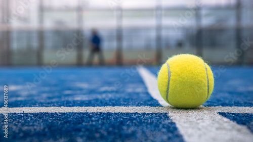 Yellow ball on floor behind paddle net in blue court outdoors. Padel tennis © REC Stock Footage