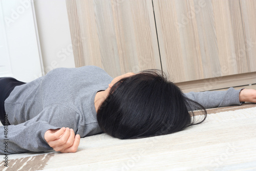 Woman lying on the floor at home. epilepsy, fainting, hypoglycemia