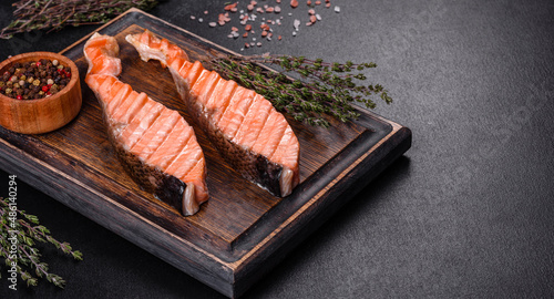 Grilled salmon with herbs served on black concrete table