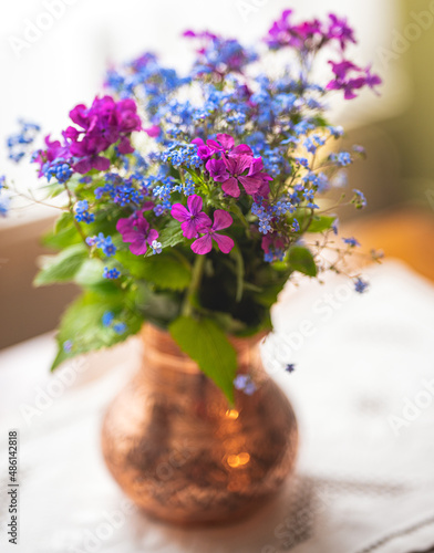 Flowers from the field in a copper vase