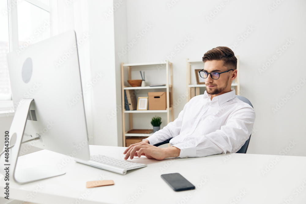handsome businessman wearing glasses sits at a desk office worked executive