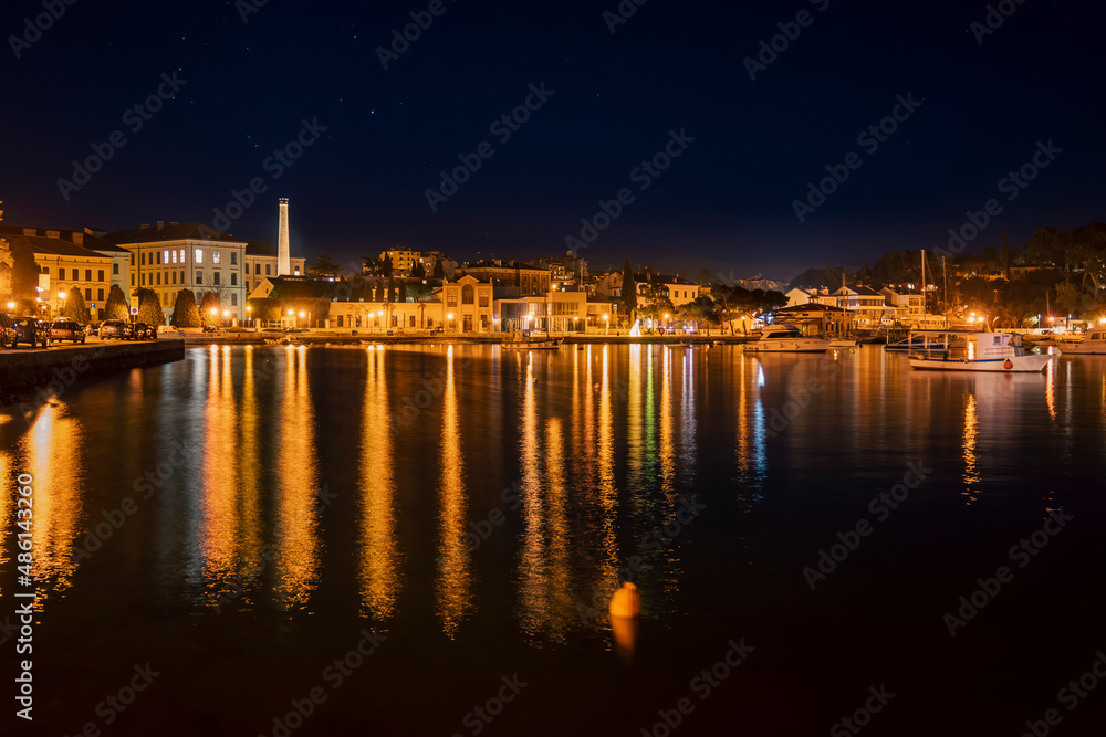 Nightfall over Rovinj town port with old industrial architecture visible across the bayNightfall over Rovinj town port with old industrial architecture visible across the bay