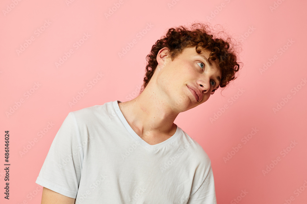 portrait of a young curly man summer clothes white tshirt posing Lifestyle unaltered portrait of a young curly man summer clothes white tshirt posing Lifestyle unaltered