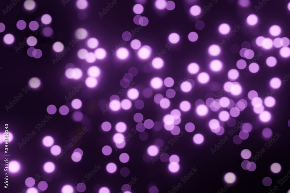 Defocused bokeh lights on black background, an abstract naturally blurred backdrop for Valentines Day or birthday party. Festive light texture. Violet blue garland in blur. Color 2022 Defocused bokeh lights on black background, an abstract naturally blurred backdrop for Valentines Day or birthday party. Festive light texture. Violet blue garland in blur. Color 2022