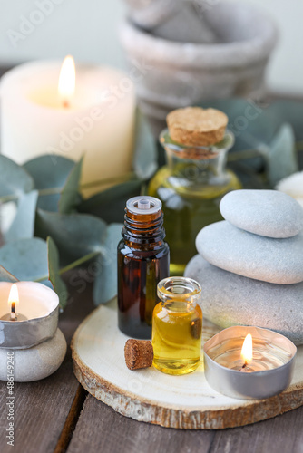 Assortment of natural oils in glass bottles on wooden background. Concept of pure organic ingredients in cosmetology. Bath accessories  atmosphere of harmony  relax. Close up macro. Healthy lifestyle
