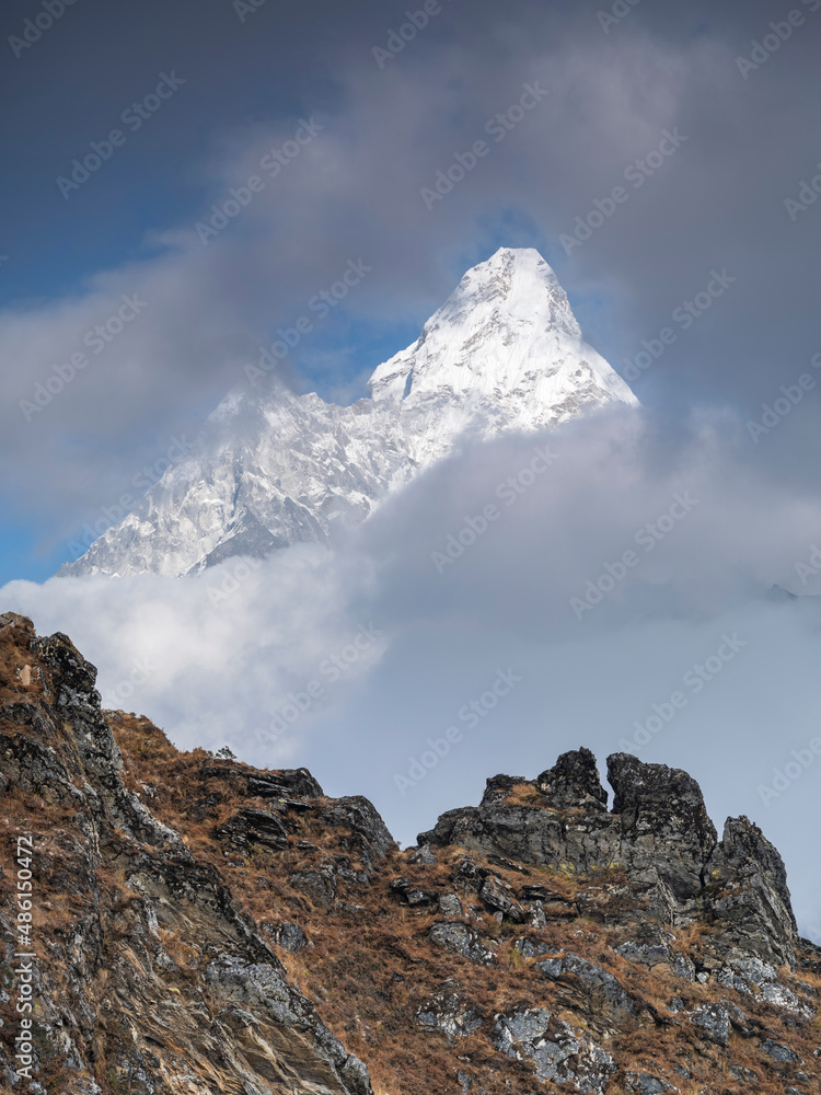 view to peak Ama-Dablam behind rock hill in Nepal view to peak Ama-Dablam behind rock hill in Nepal