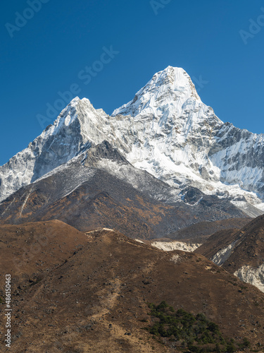 coffee colours of hills and view to snow peak Ama-Dablam under blue sky in Nepal
