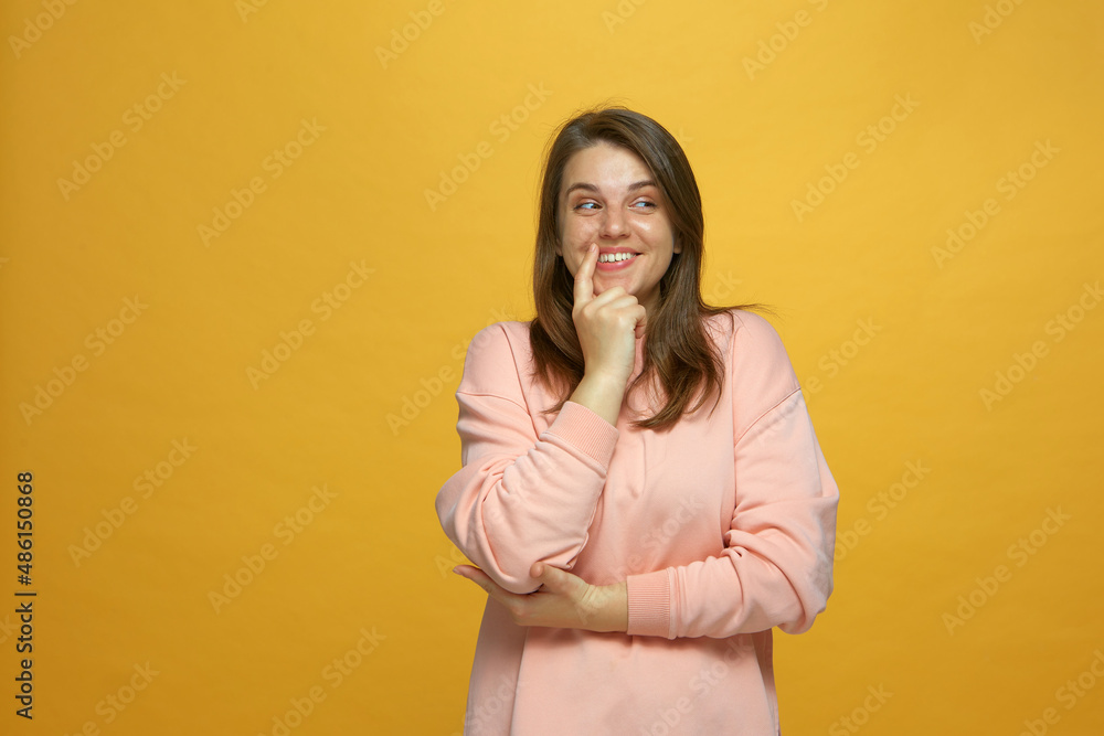 Cheerful playful young girl smiling looking aside, thinking creative idea, dreaming in anticipation of online store sale Cheerful playful young girl smiling looking aside, thinking creative idea, dreaming in anticipation of online store sale