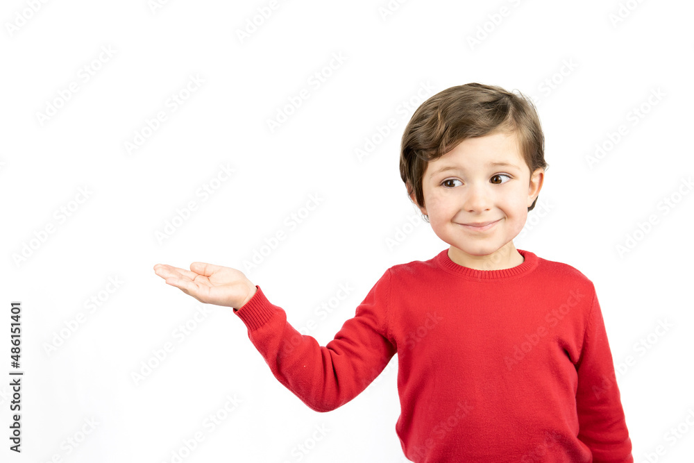 Little boy in red sweater pointing with hand on white background. Little boy in red sweater pointing with hand on white background.