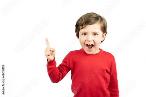 Portrait of cheerful boy pointing to the right - isolated over white background.