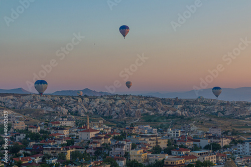 Early morning aerial view of hot air balloons above Goreme village in Cappadocia, Turkey