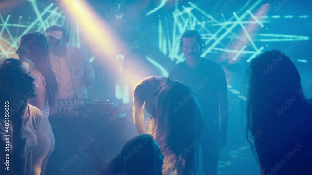 Group of young women waving with long hairs while dancing in club. Nightlife, modern music and entertainment concept. Group of young women waving with long hairs while dancing in club. Nightlife, modern music and entertainment concept.