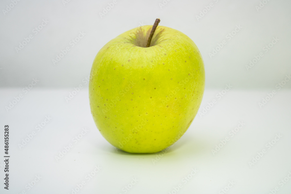 One small green apple with white background One small green apple with white background
