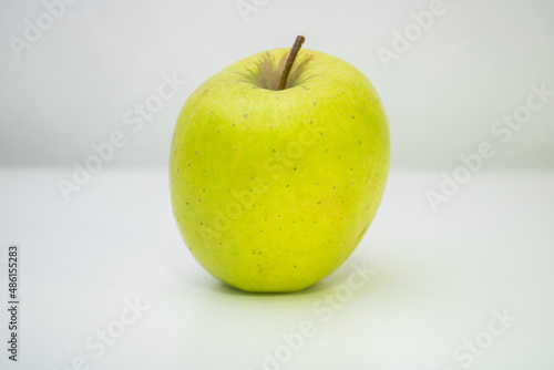 One small green apple with white background