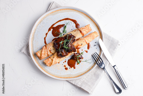 Pancakes with meat, pancakes with beef on a white background, Russian cuisine