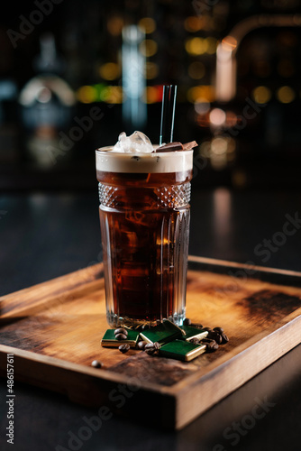 Cocktail with rum cola and ice garnished with chocolate pieces and coffee beans. Good choice for the weekend.