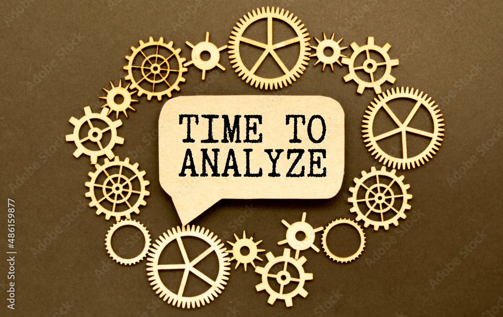 Business and finance concept. On the table are office items and a cardboard with the inscription - time to analyze