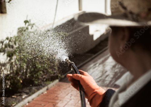 A woman watering a garden 