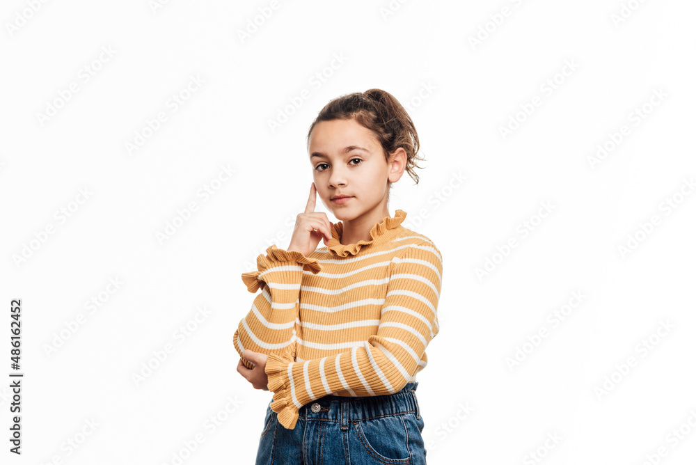 Young girl looking serious to the camera while standing over an isolated white background. Young girl looking serious to the camera while standing over an isolated white background.