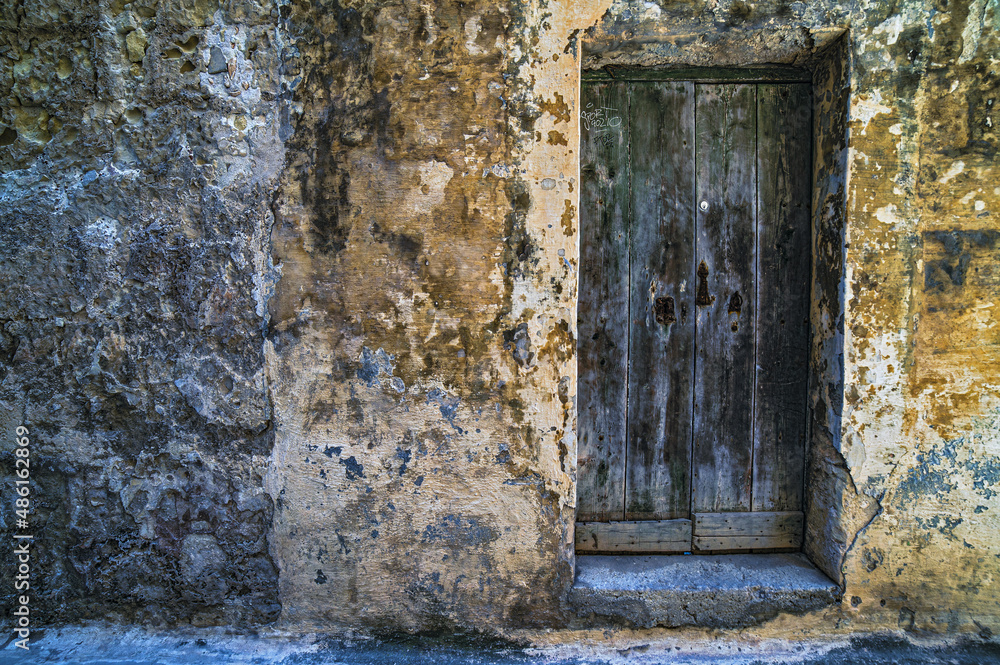 A Limestone Wall and an old medieval door in Mdina A Limestone Wall and an old medieval door in Mdina