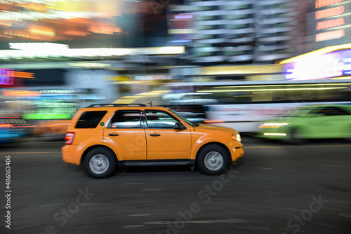 Fototapeta Naklejka Na Ścianę i Meble -  Quick pan of a yellow taxi passing through the Times Square area in NYC, USA