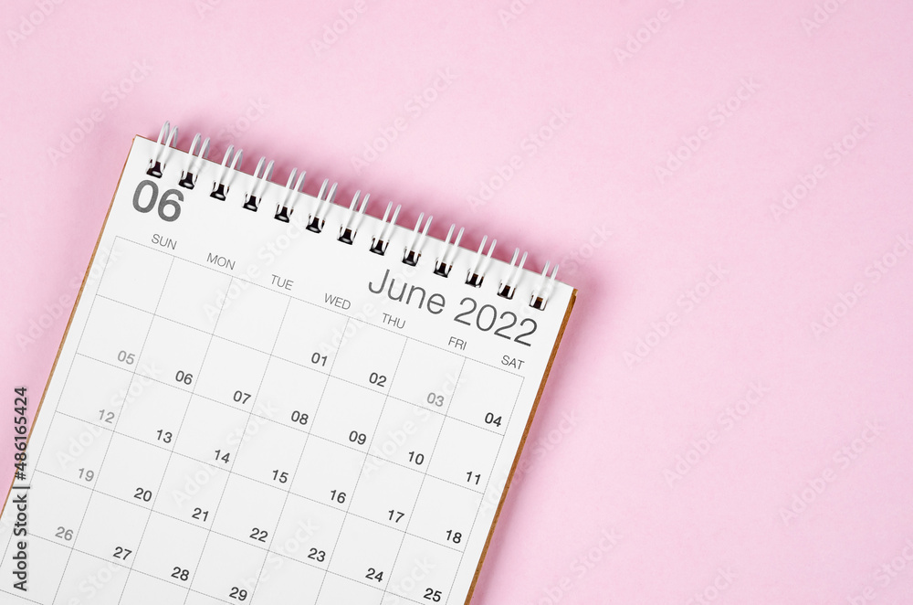 June 2022 desk calendar on pink background with empty space. June 2022 desk calendar on pink background with empty space.