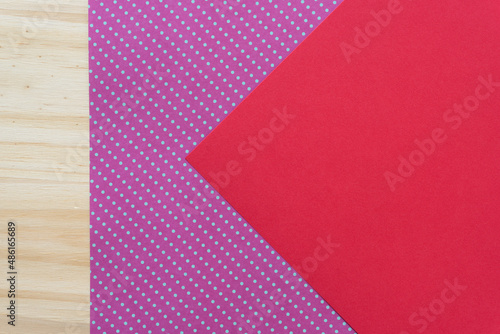 background with red paper, polka dots, and wood