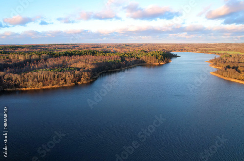 Lake on sunset in autumn season. Aerial panoramic landscape view of lake in village of Staroselye  Chashniki region  Belarus. Drone view of lake in spring. Aerial view of wetland in fall colors..